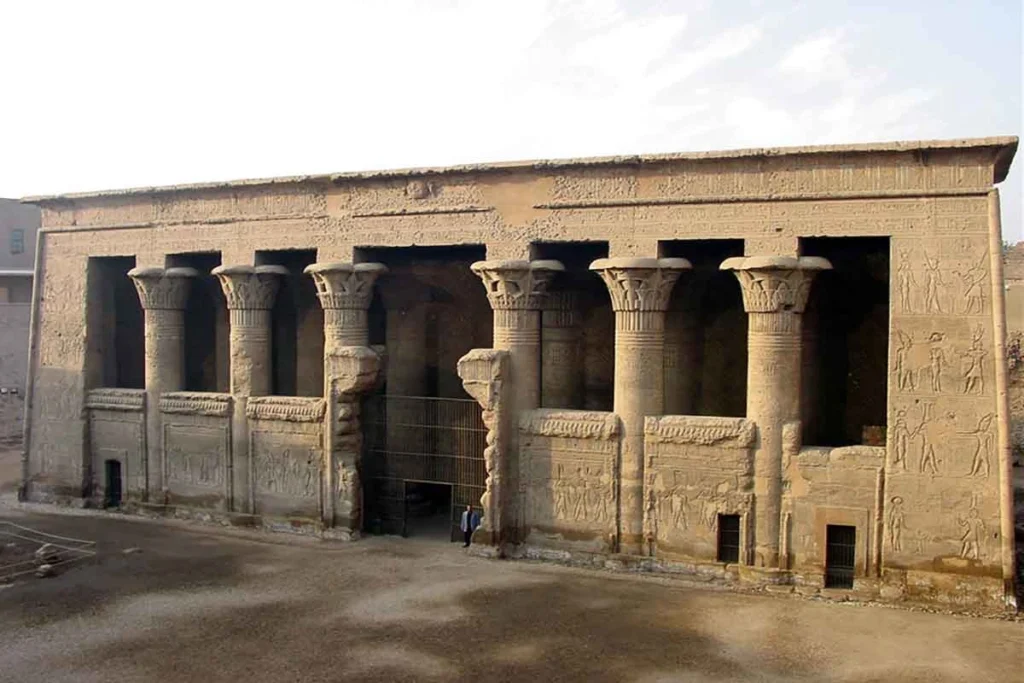 Exterior view of Esna Temple with columns and carvings.