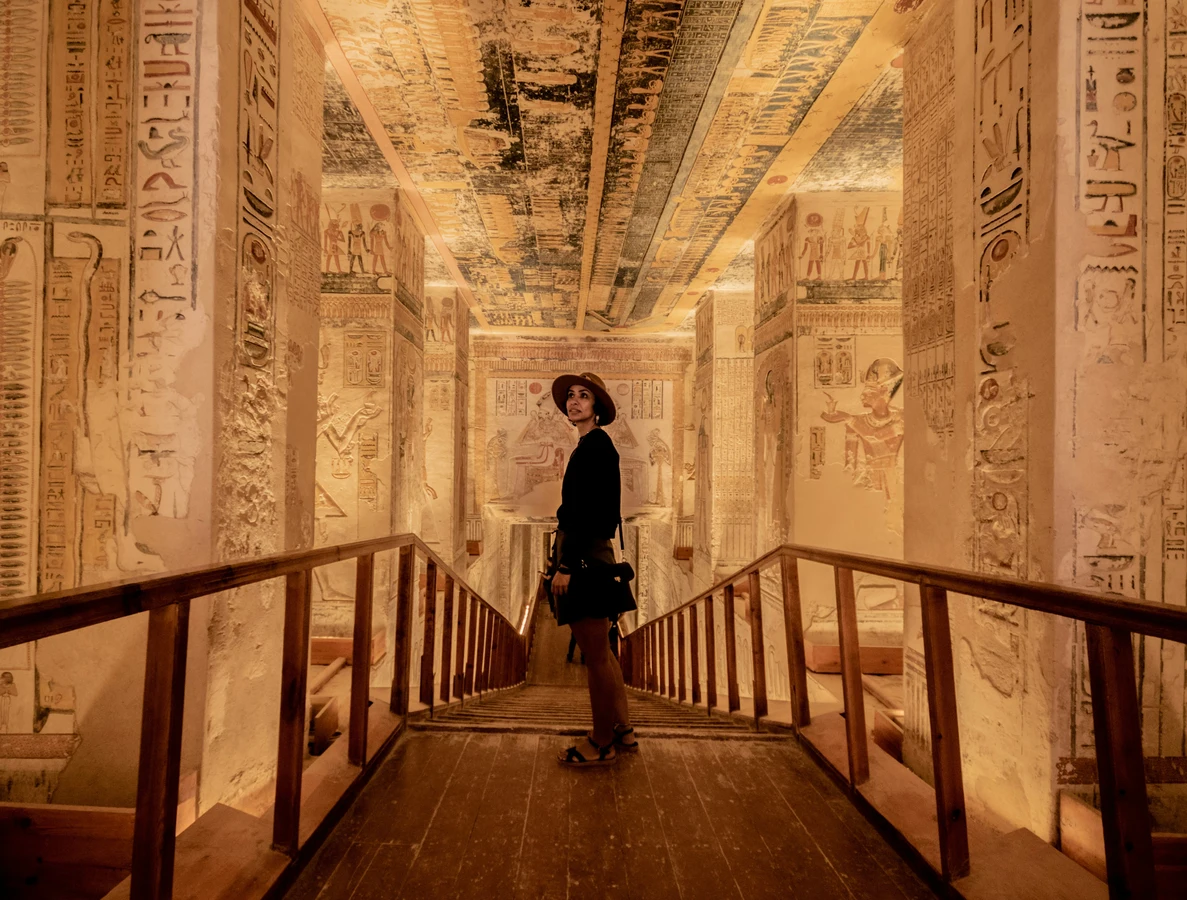 Interior of a pharaoh’s tomb in the Valley of the Kings, Luxor, Egypt, with colorful hieroglyphs and golden lighting.